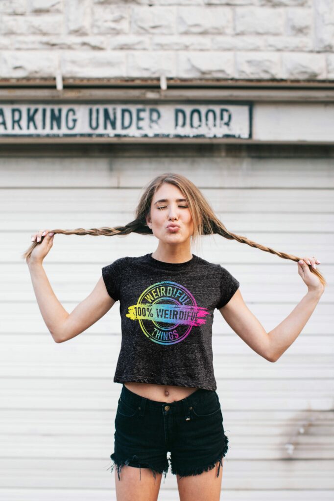 woman, 100 percent weirdiful tshirt, braids, kissy face, teasing